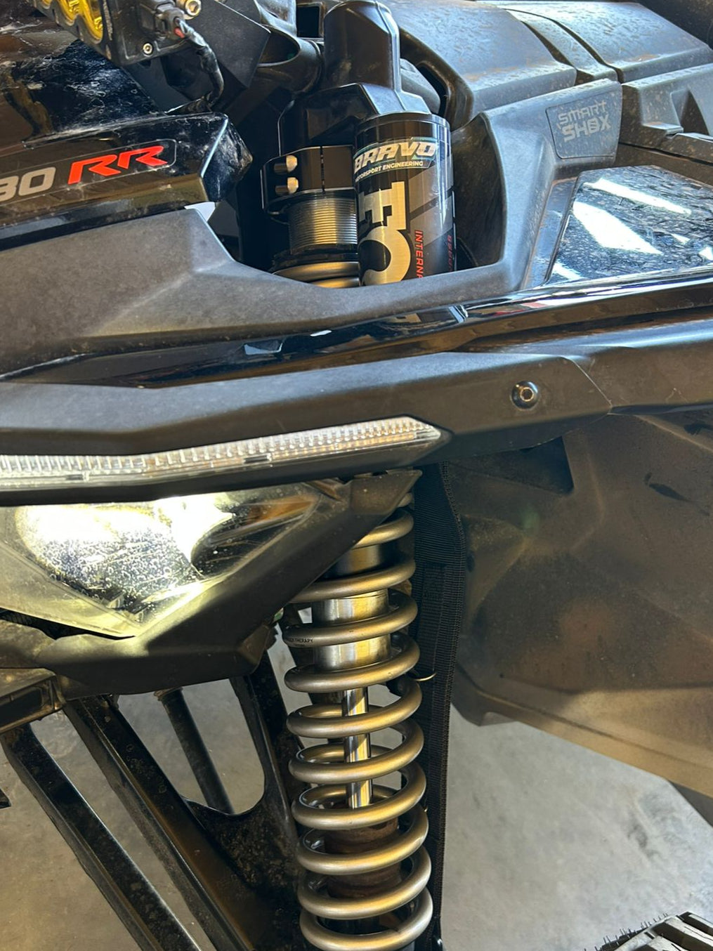 Close-up of a suspension system on a vehicle with 'Can-Am' branding.